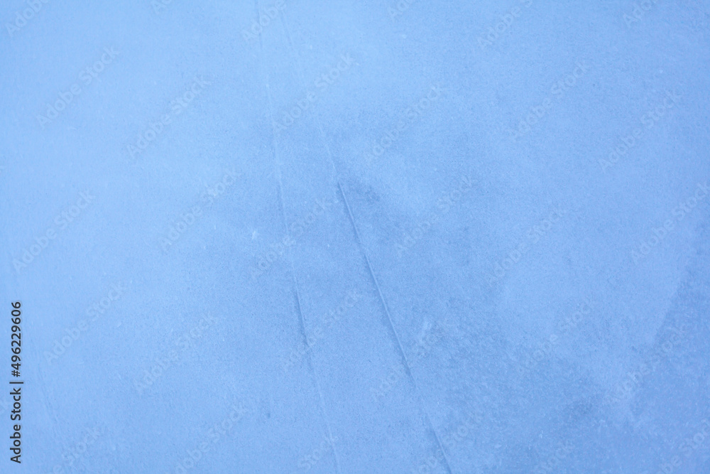 Poster empty ice rink with skate marks after the session outdoor. skating ice rink texture covered with sno