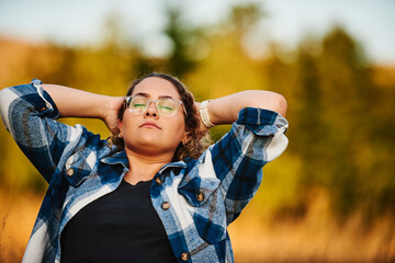 The woman is resting from hiking in nature. Selective focus