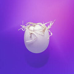 A simple concept of Easter. Half of a white eggshell with a handmade bright nest inside. Abstract nest and free expression. The hipster idea of a modern Easter. Futuristic neon. Violet wallpaper.