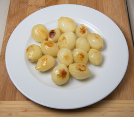 Preparing fresh white onions cooked on plate