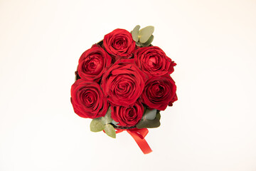 Gentle colourful bouquet of red roses on white background, close-up