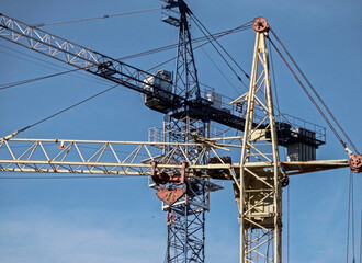 Construction cranes against the blue sky. Industrial background. Construction site. Ust-Kamenogorsk (kazakhstan)