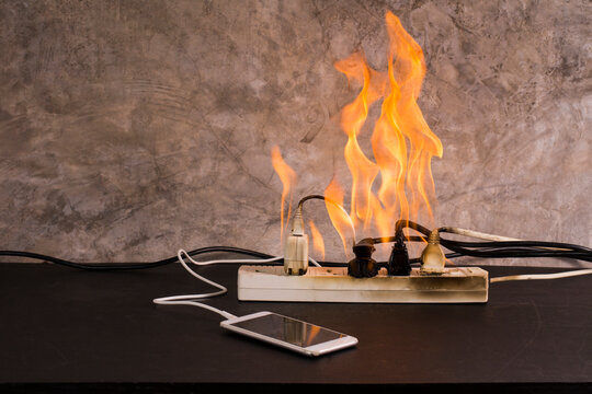 Short circuit An electrical outlet or electronic device bursts into flames while charging a mobile phone battery. Using a substandard plug or cord