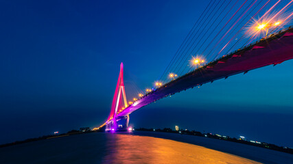 Fototapeta na wymiar Shimmering night lights by Can Tho bridge, Vietnam