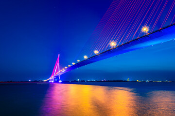 Shimmering night lights by Can Tho bridge, Vietnam