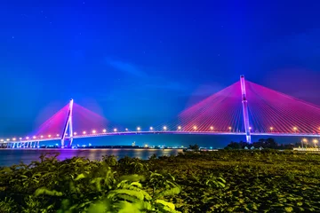 Papier Peint photo Bleu foncé Shimmering night lights by Can Tho bridge, Vietnam