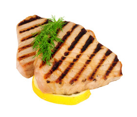 Two grilled yellow fin tuna fish meat steaks with lemon and dill herb garnish