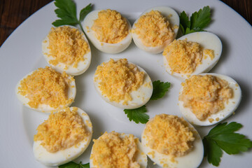 Stuffed eggs with crab crumbs, mayonnaise and parsley macro on a plate
