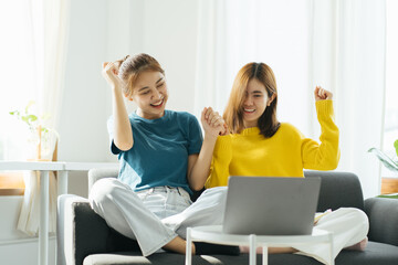 Excited female feeling euphoric celebrating online win success achievement result, young asian...