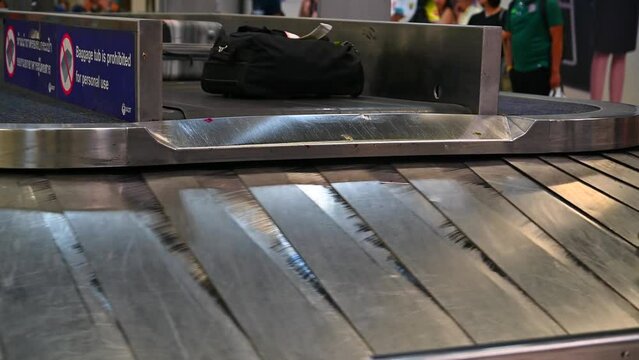 Various suitcases on a conveyor belts in the international airport