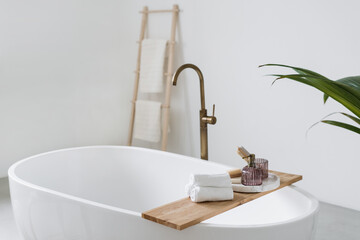 Fresh folded towels on shelf over tub