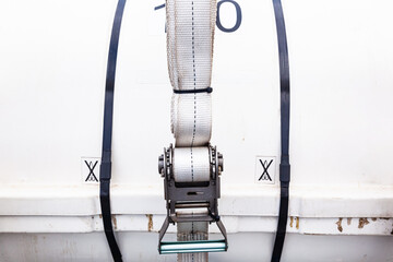 A liferaft in a capsule is fixed on the deck of the ship in close-up. The mechanism for fastening...