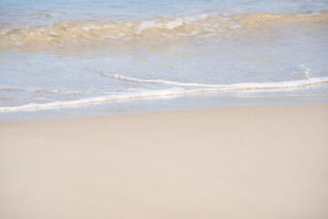 Fototapeta na wymiar White sand waves texture lapping across untouched Shore.