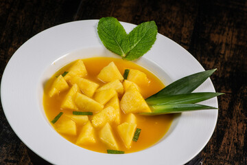 Fresh pineapple dessert recipe with mint orange coulis