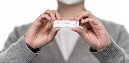Close up of holding express antigen covid test, negative result