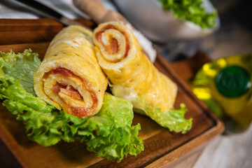 Tomato-rolled egg omelette recipe on a bed of salad, High quality photo