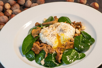 Recipe for poached egg with black tea cut with a knife, warm salad of chanterelles, High quality photo