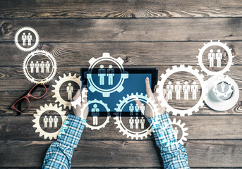 Concept of teamworking and connection with gears mechanism and tablet pc