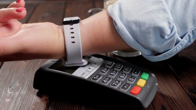 Customer paying bill through smartphone using NFC technology in the store.