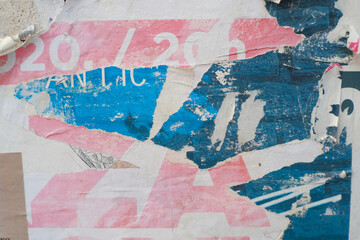 Grungy street poster background. Torn and ripped paper texture. Abstract collage layers of vintage street poster.