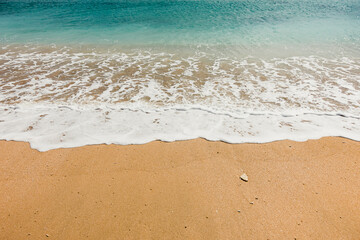 Low angle shot of sand beach with waves