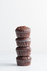 The stack of chocolate muffins on a white background
