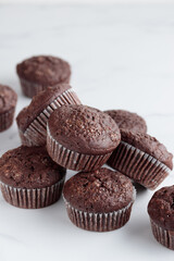 Pile of chocolate muffins on a white background