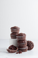 Pile of chocolate muffins on a white background