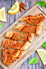  Traditional Turkish cuisine. Baked Pide dish with minced  beef, tomatoes and  herbs on  wooden background.  Turkish pizza pide