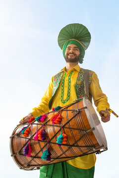 Portrait of Sikh man playing drum during Baisakhi celebration