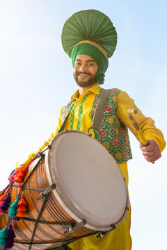 Portrait of Sikh man playing drum during Baisakhi celebration