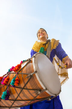 Portrait of Sikh woman playing drum during Baisakhi celebration
