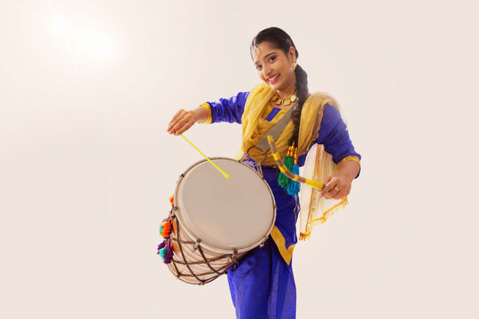 Portrait of Sikh woman playing drum during Baisakhi celebration