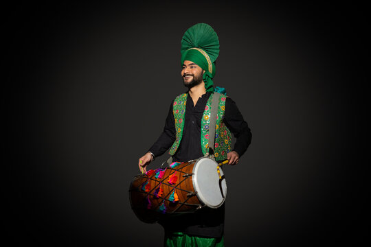 Portrait of Sikh man playing drum during Baisakhi celebration