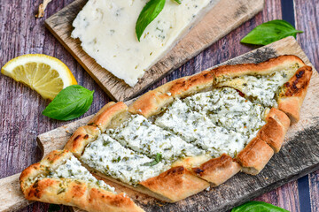  Traditional Turkish cuisine. Baked Pide dish with minced  beef, tomatoes and cheese on  wooden background.  Turkish pizza pide