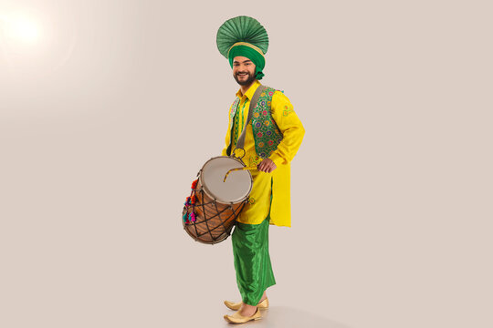 Portrait of Sikh man playing drum during Baisakhi celebration