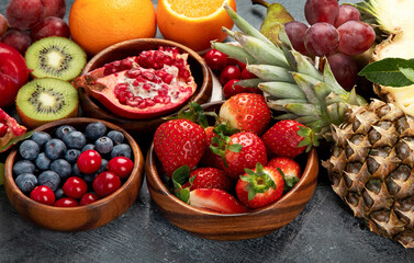 Delicious raw fruit on dark background.