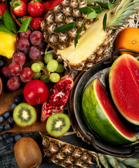 Delicious raw fruit on dark background.