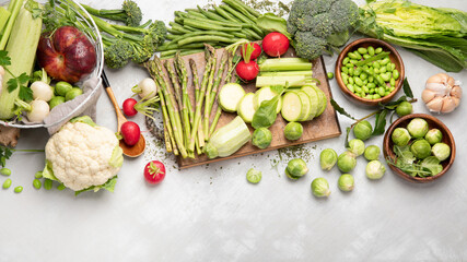 Raw and fresh spring vegetables on light background.
