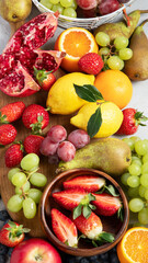 Obraz na płótnie Canvas Assortment of colorful ripe tropical fruits on light gray background.