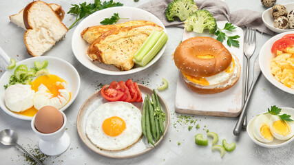 Various ways of cooking chicken eggs on light background.