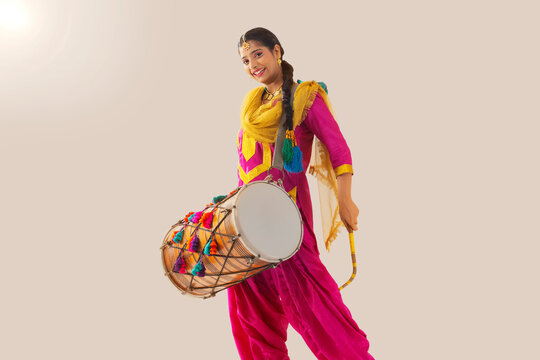Portrait of Sikh woman playing drum during Baisakhi celebration