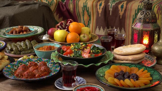 Eid mubarak. Traditional Middle Eastern cuisine, evening meal. Ramadan iftars marks the end of fasting. Holiday islamic table with dates, Oriental food and sweets.