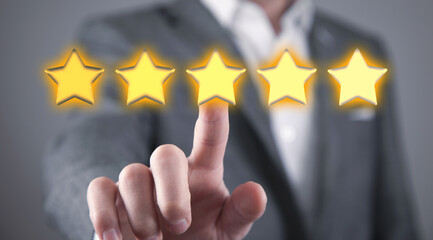 Male hand touching five star rating.