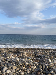 Fototapeta na wymiar View on the stones mediterranean beach in Antalya, Turkey