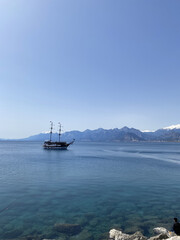 view of gulf of Antalya in Turkey with the ship on the sea surface and mountain on horizon