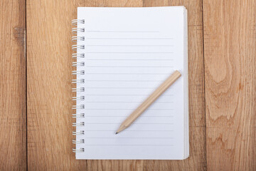 Open Notebook, Lined paper with a pencil on wooden background