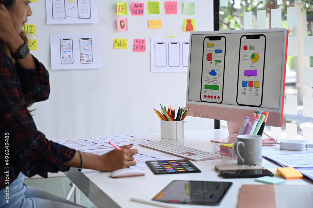 Poster young female website designer working in a studio to create application for mobile phone.