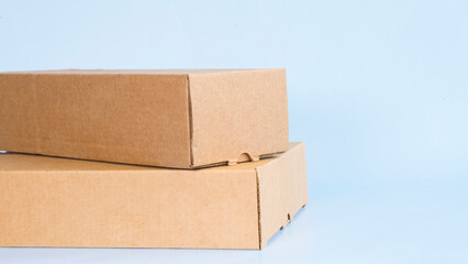 Two cardboard boxes on a light blue background