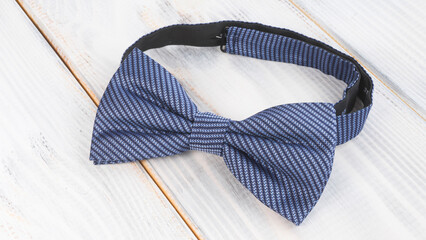 Blue men's bow tie on a wooden background